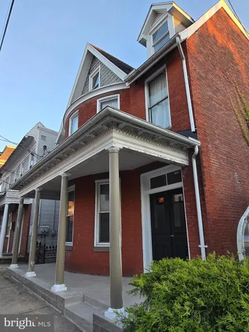 a front view of a house with a small porch