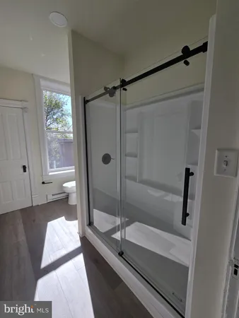 a bathroom with a tub and a window