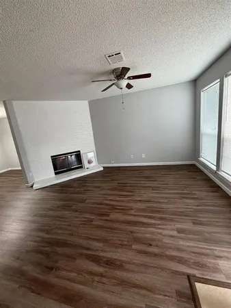 a view of wooden floor and windows in a room