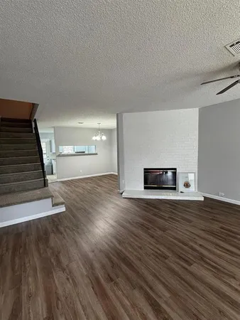 a view of a livingroom with wooden floor and fireplace