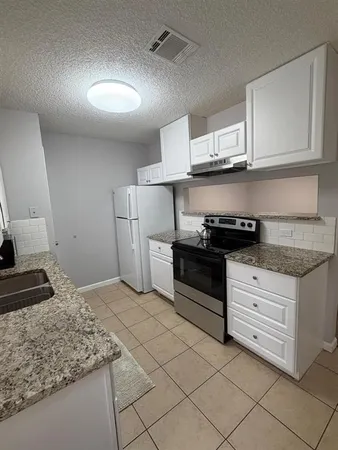 a kitchen with stainless steel appliances granite countertop a stove and a sink
