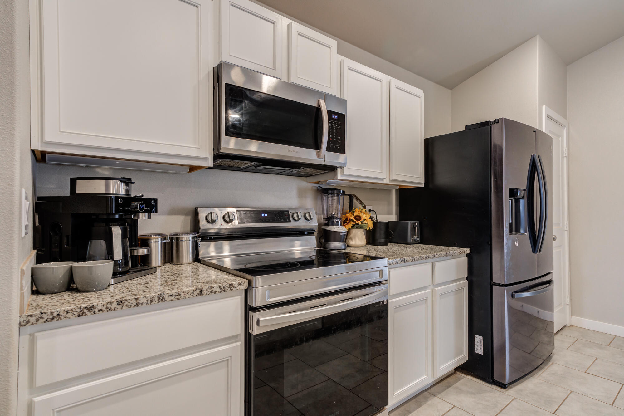 7429 31st Street Lubbock, TX 79407 - Photo 11 of 29 a kitchen with stainless steel appliances granite countertop white cabinets and a refrigerator