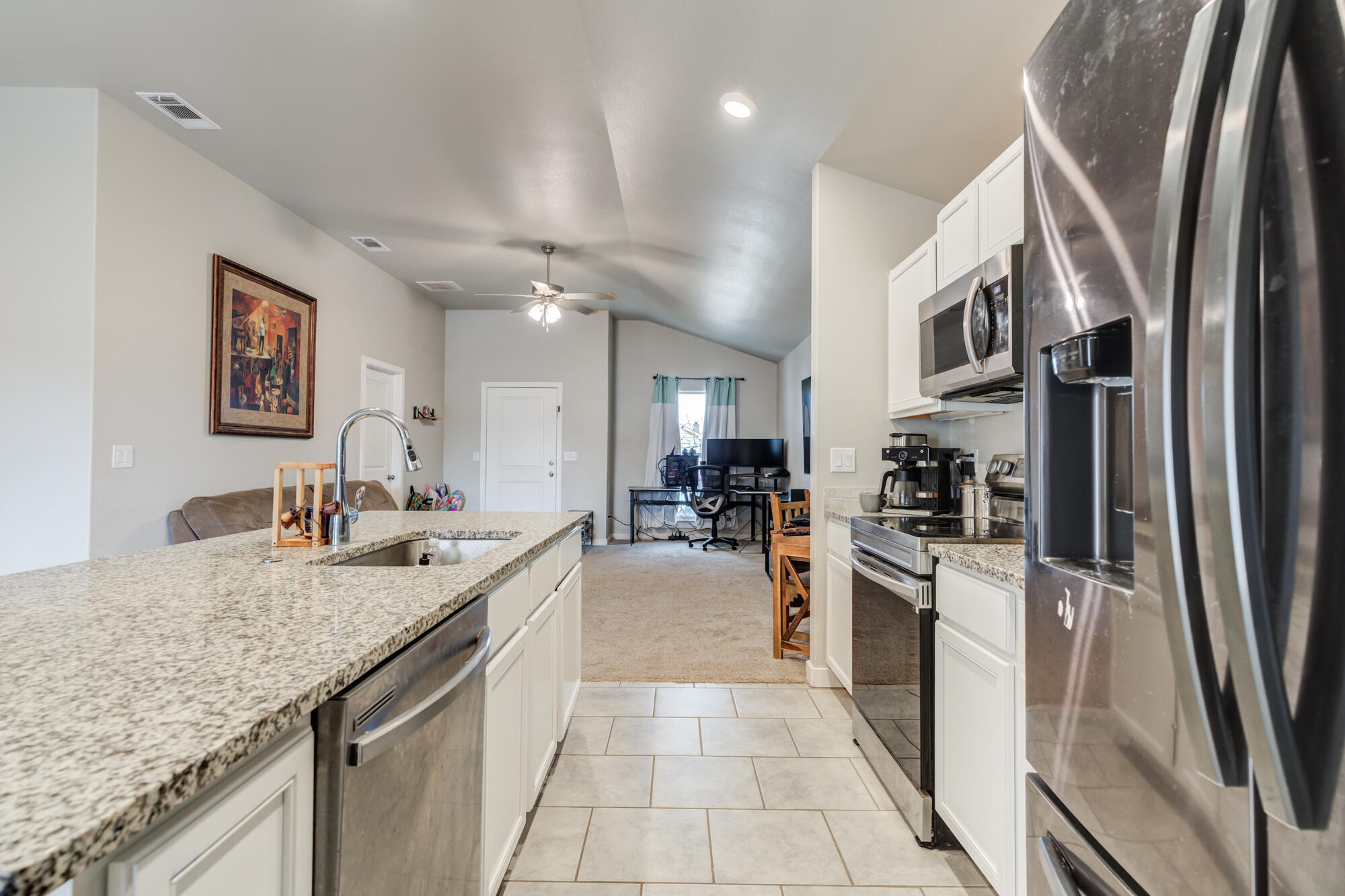 7429 31st Street Lubbock, TX 79407 - Photo 13 of 29 a large kitchen with stainless steel appliances granite countertop a lot of counter space