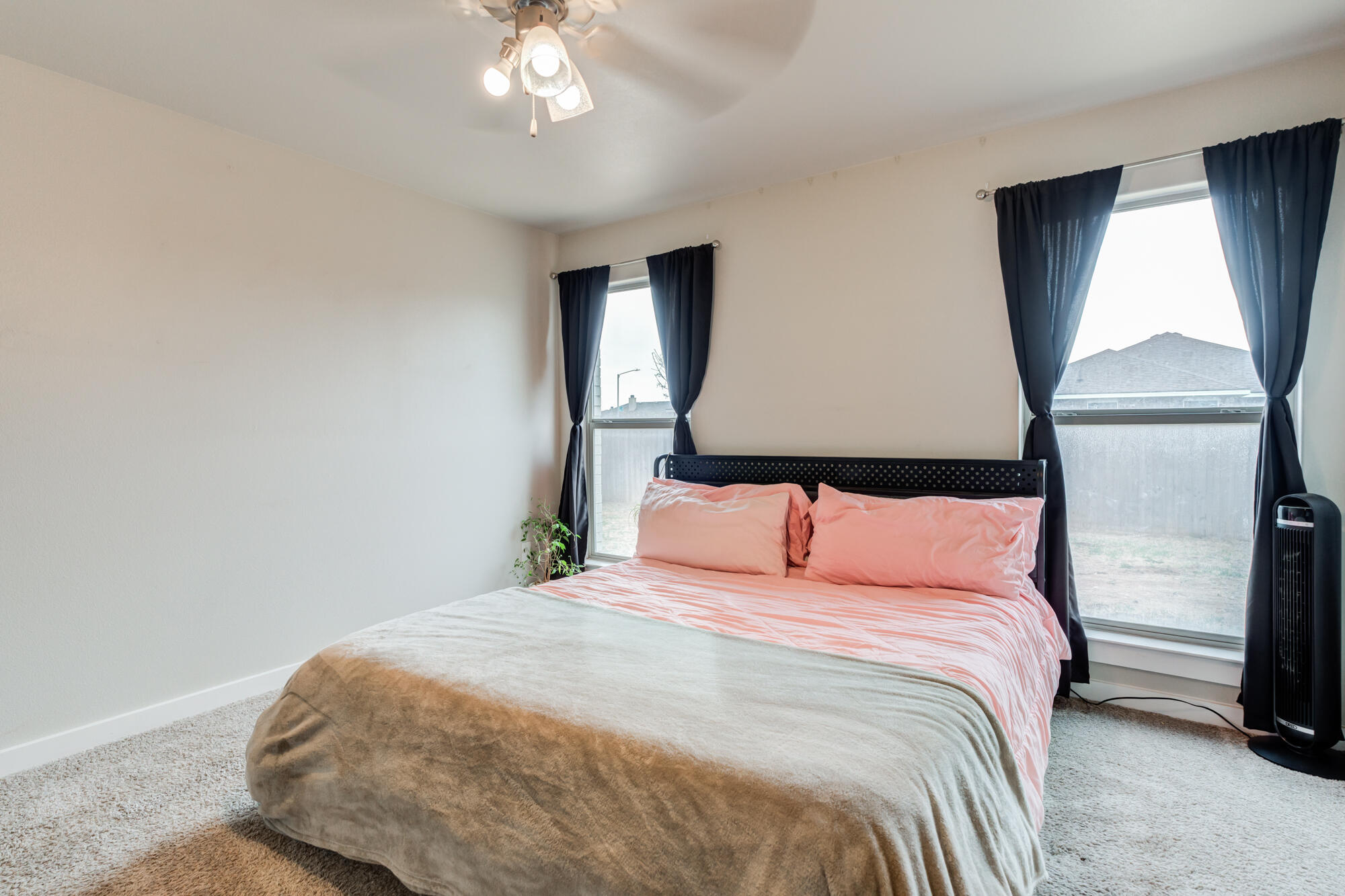 7429 31st Street Lubbock, TX 79407 - Photo 17 of 29 a bedroom with a bed and a painting on the wall