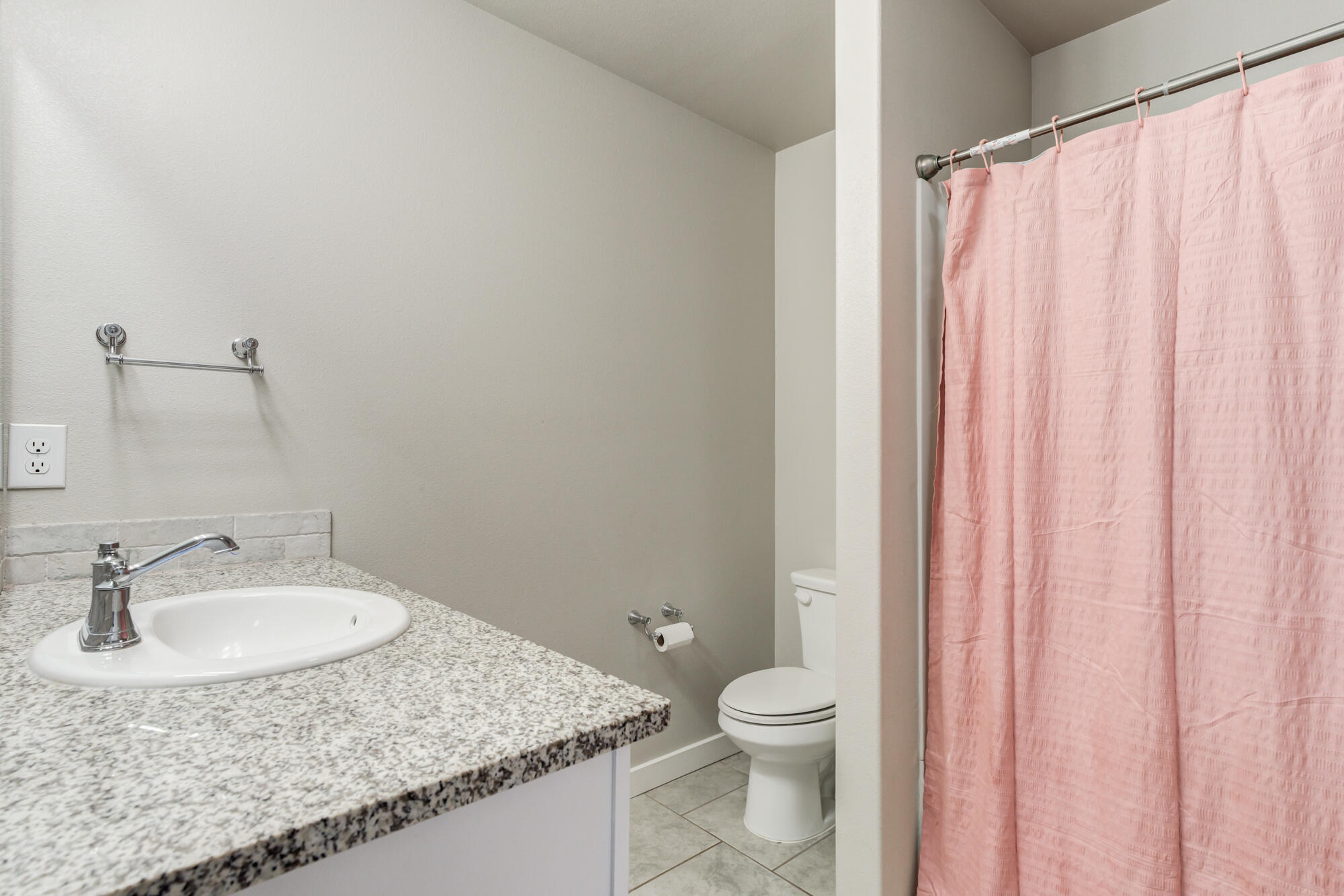 7429 31st Street Lubbock, TX 79407 - Photo 18 of 29 a bathroom with a granite countertop sink and a mirror