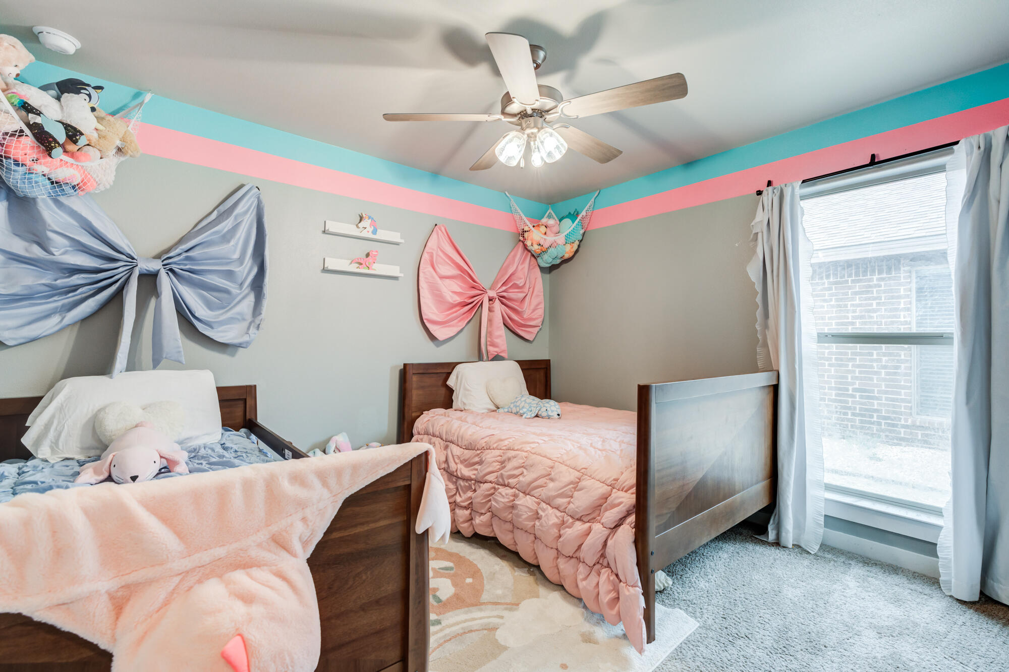 7429 31st Street Lubbock, TX 79407 - Photo 20 of 29 a bedroom with a bed and a chandelier