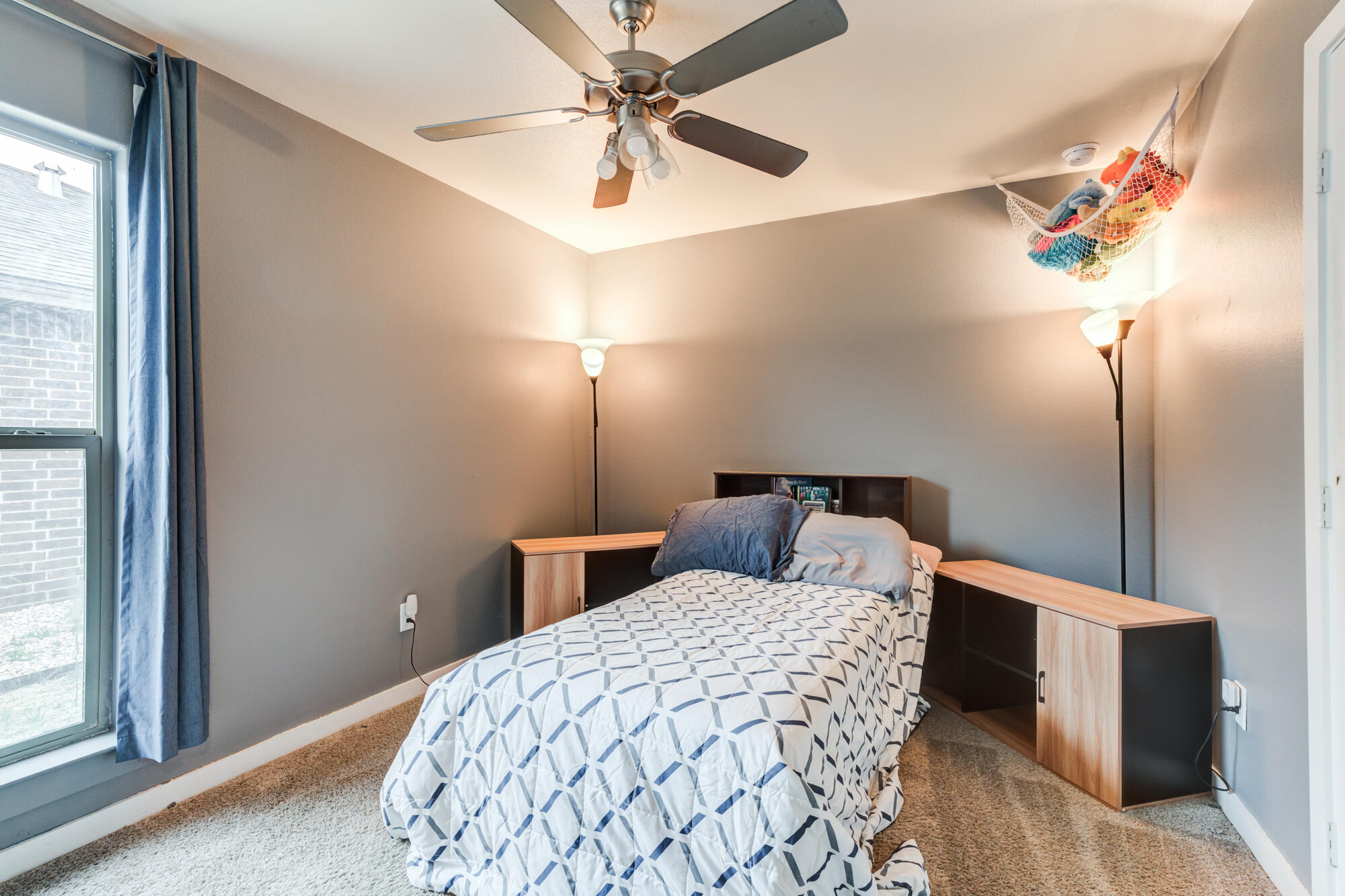 7429 31st Street Lubbock, TX 79407 - Photo 22 of 29 a bedroom with a bed and a chandelier