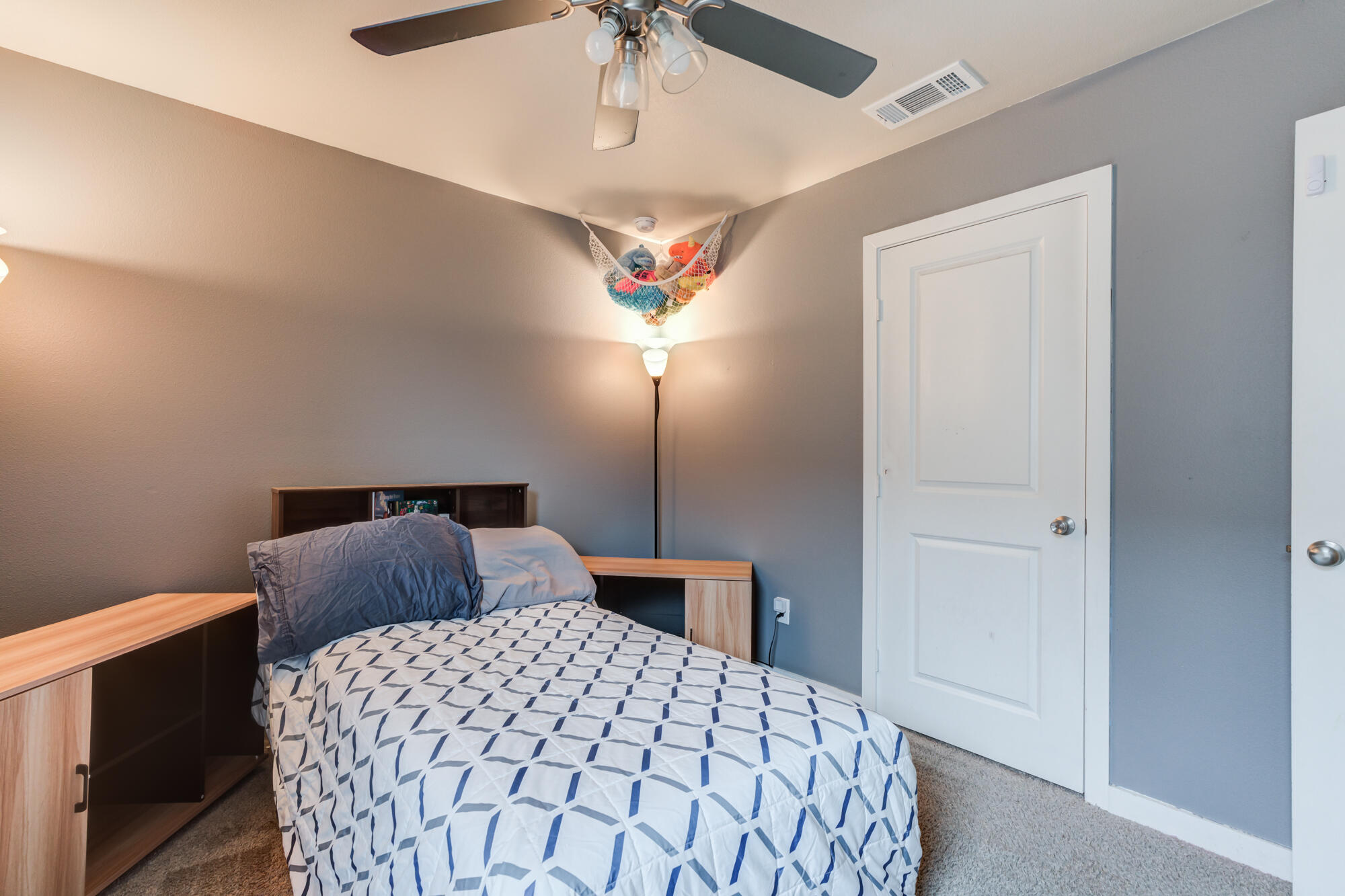 7429 31st Street Lubbock, TX 79407 - Photo 23 of 29 a bedroom with a bed and a chandelier
