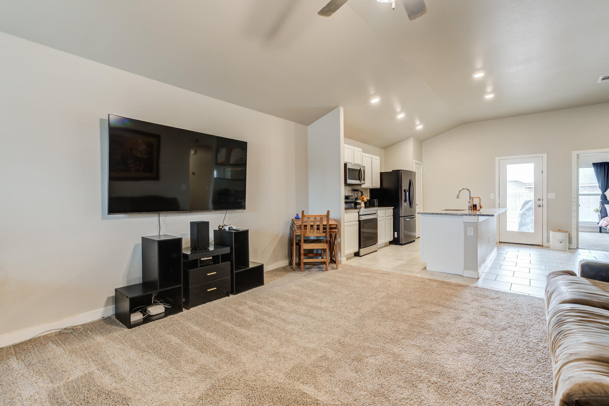 7429 31st Street Lubbock, TX 79407 - Photo 4 of 29 a view of a livingroom with furniture and a flat screen tv