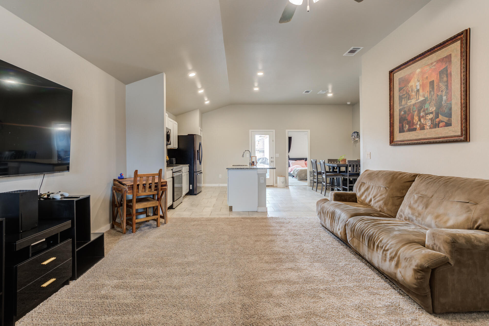 7429 31st Street Lubbock, TX 79407 - Photo 5 of 29 a living room with furniture and a flat screen tv