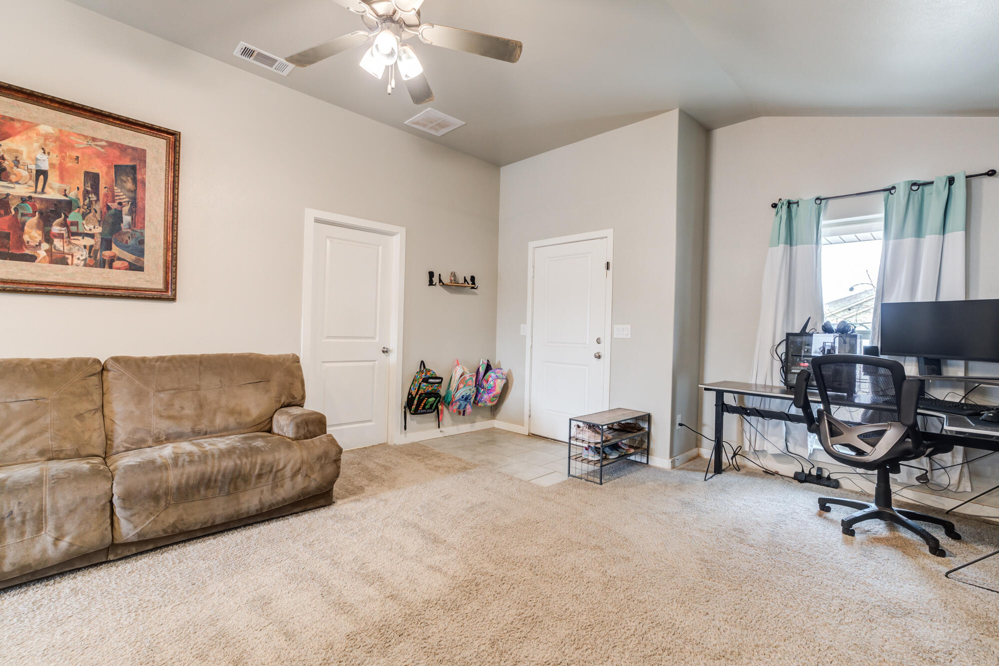 7429 31st Street Lubbock, TX 79407 - Photo 7 of 29 a living room with furniture and a flat screen tv