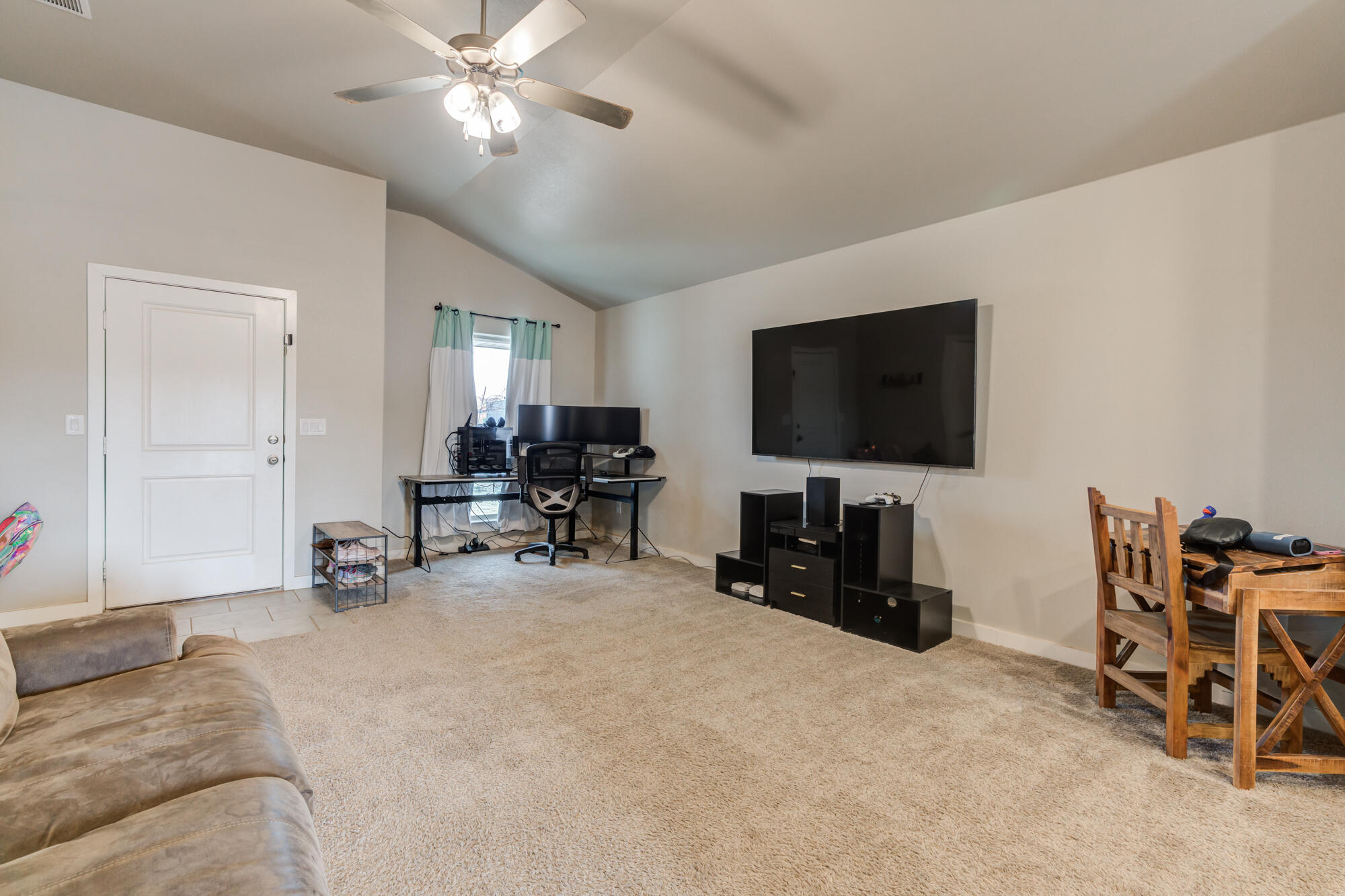 7429 31st Street Lubbock, TX 79407 - Photo 8 of 29 a view of a livingroom with furniture and a flat screen tv