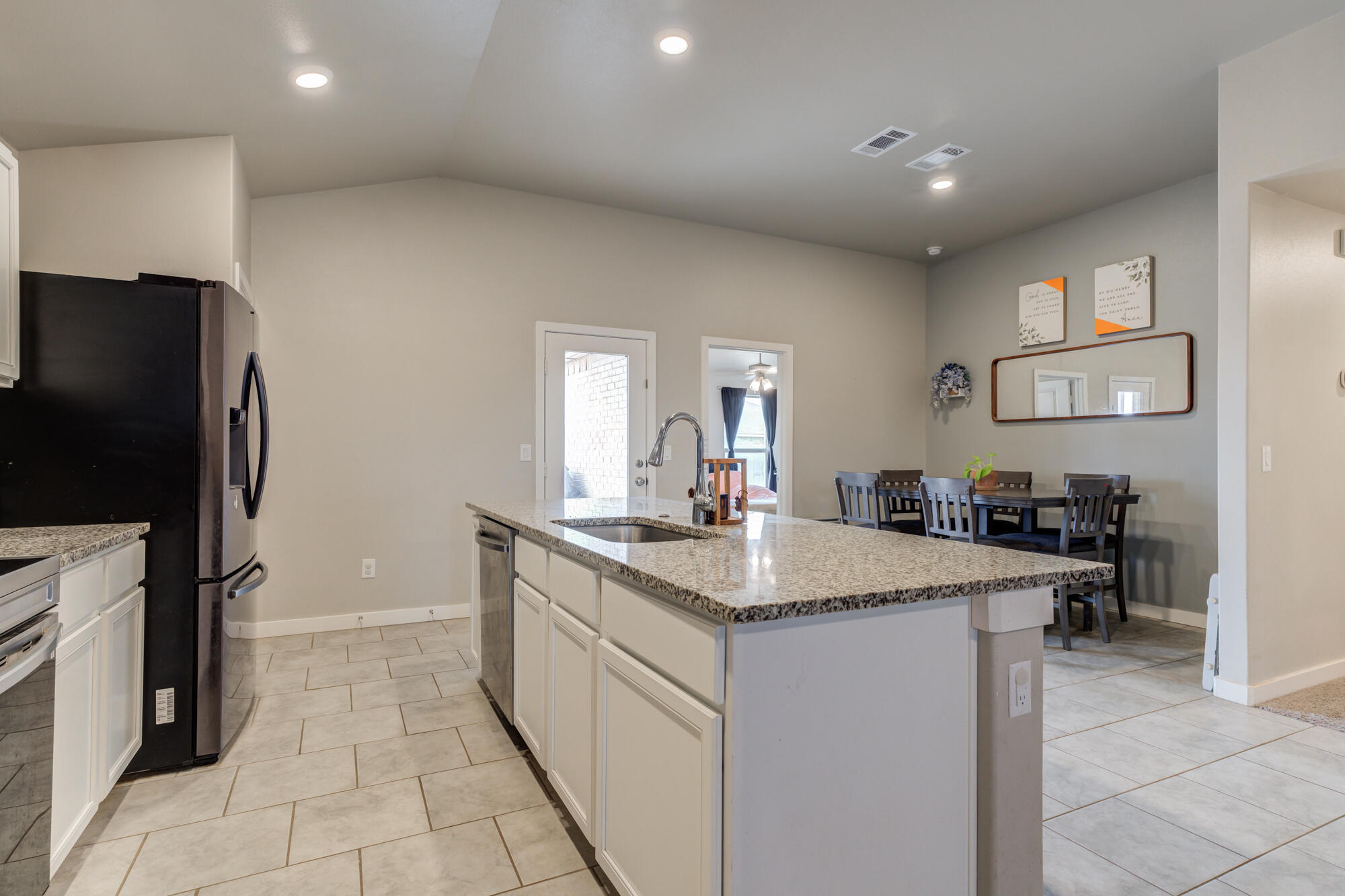 7429 31st Street Lubbock, TX 79407 - Photo 10 of 29 a kitchen with a sink a refrigerator and a stove