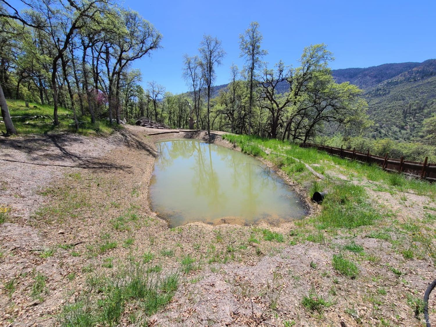 35776 Mendocino Pass Road Covelo, CA 95428 - Photo 11 of 33 a view of a water pond with green yard