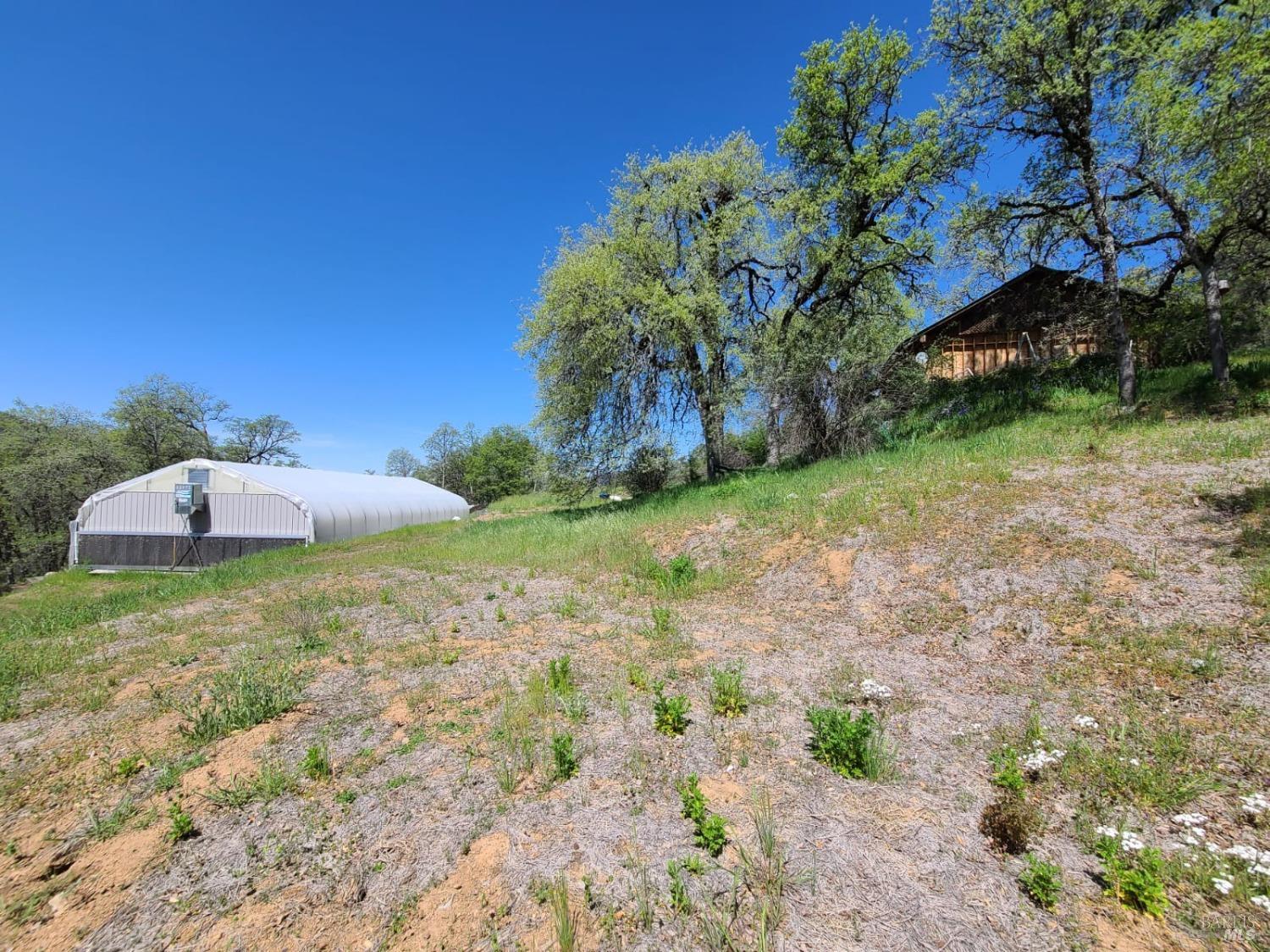 35776 Mendocino Pass Road Covelo, CA 95428 - Photo 29 of 33 a backyard of a house with a garden and deck