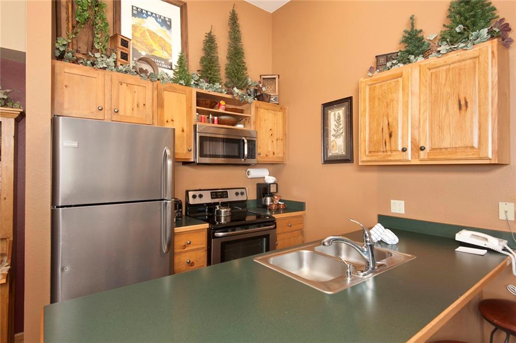 129 River Run Road, Unit 8071 Keystone, CO 80435 - Photo 3 of 21 a kitchen with stainless steel appliances granite countertop a refrigerator a stove a sink a stove and a refrigerator