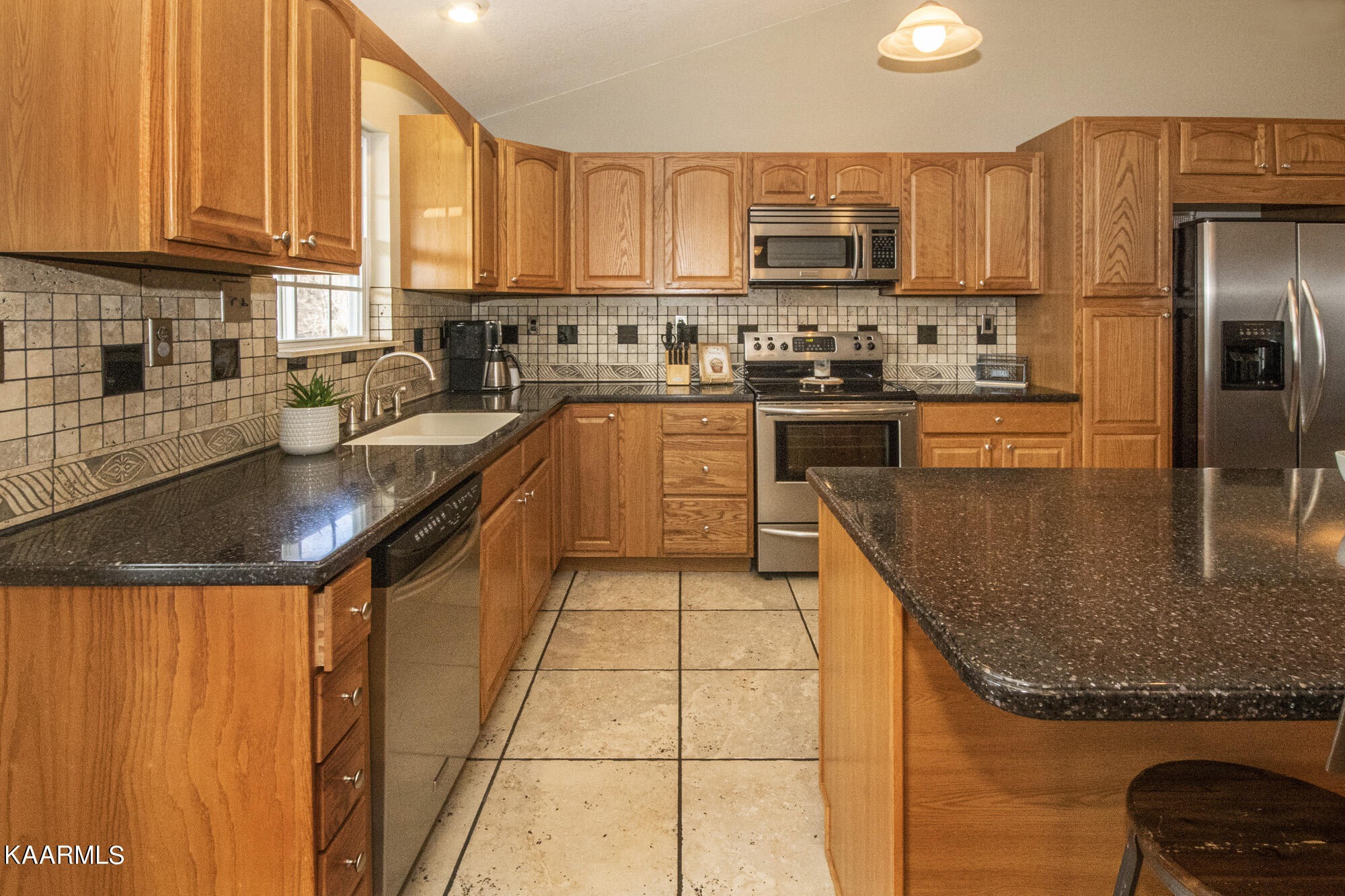 8115 Campbells Point Road Corryton, TN 37721 - Photo 8 of 41 a kitchen with stainless steel appliances granite countertop a stove a sink and a refrigerator