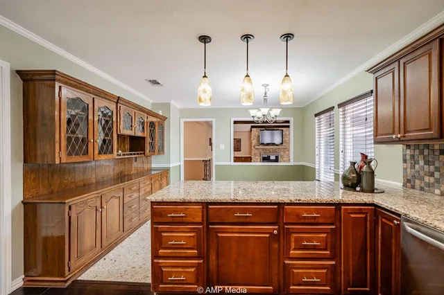 a kitchen with stainless steel appliances granite countertop a sink and a granite counter tops