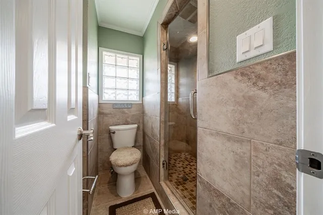 a view of a livingroom with wooden floor and a ceiling fan