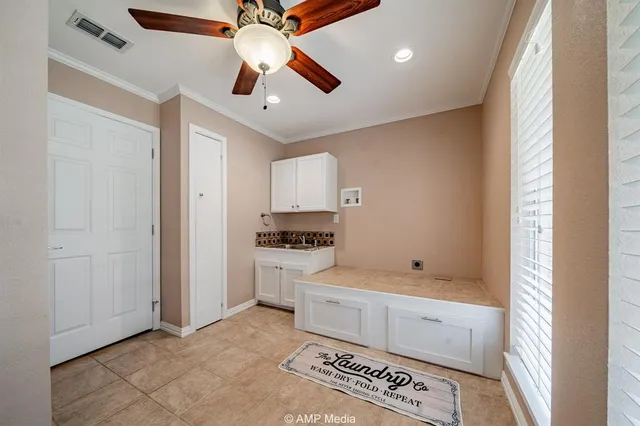 a spacious bathroom with a granite countertop sink and a mirror