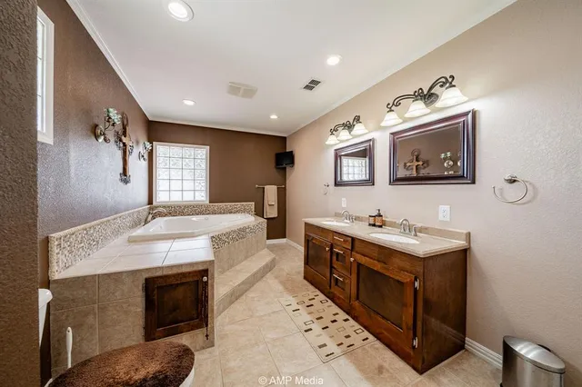 a bathroom with a sink double vanity and tub