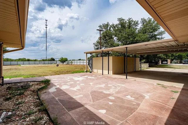 a view of backyard with wooden fence