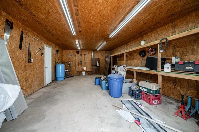 an aerial view of a house with swimming pool patio and lake view