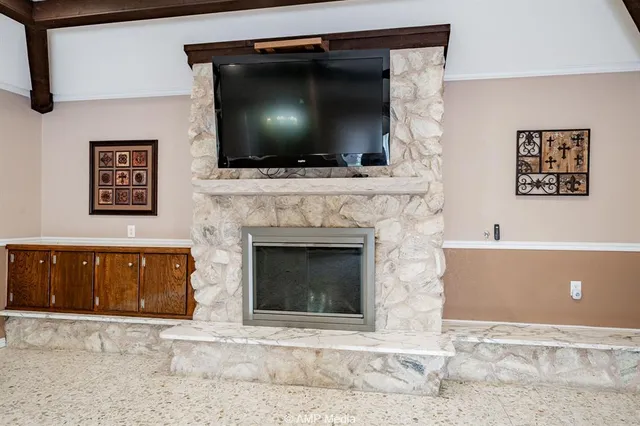 a living room with a fireplace and a flat screen tv