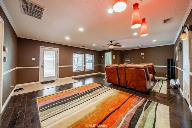 a living room with furniture a table and kitchen view