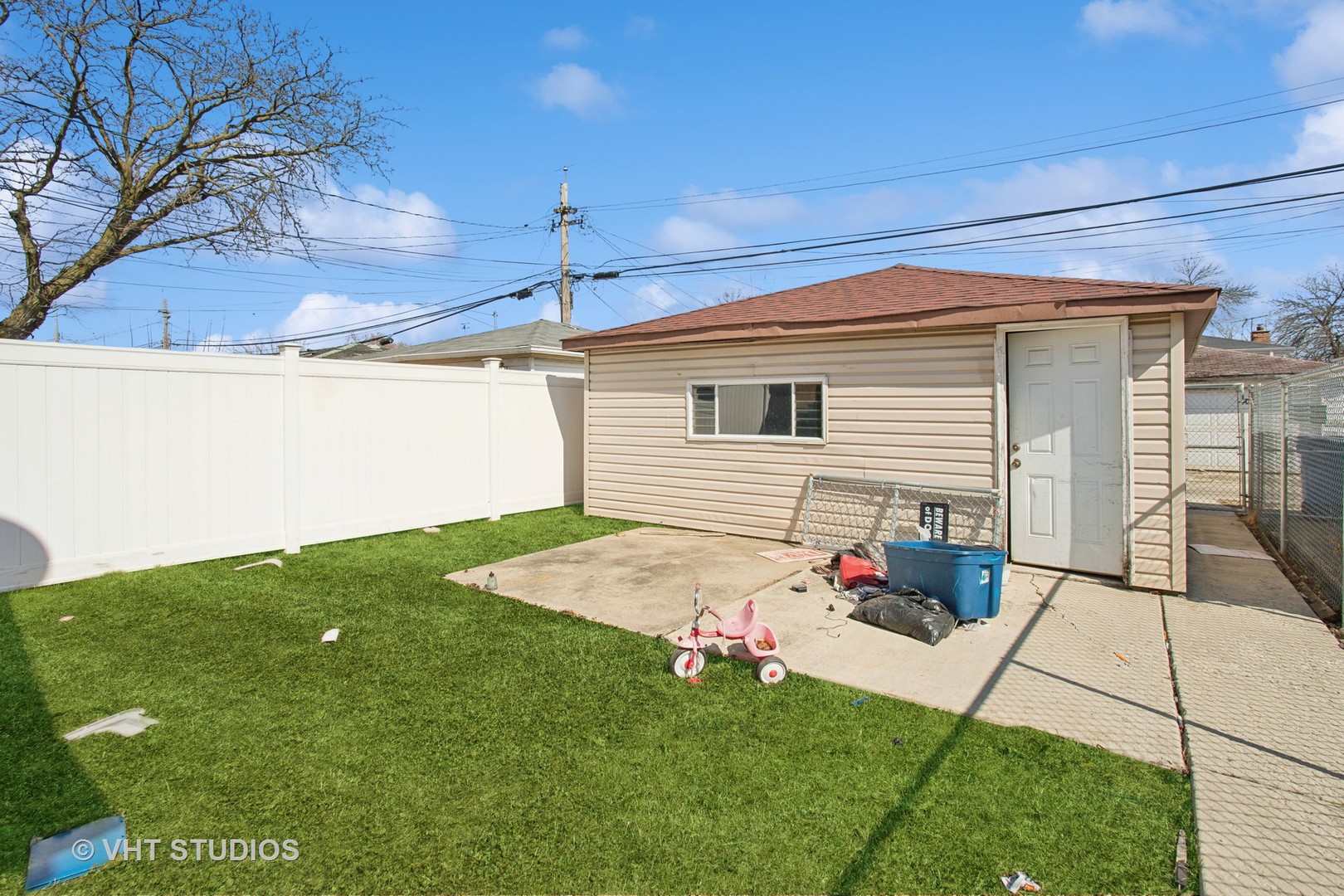 9407 South Normal Avenue Chicago, IL 60620 - Photo 15 of 18 a backyard of a house with table and chairs
