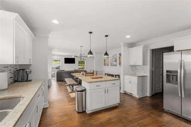 a large kitchen with a large window and stainless steel appliances