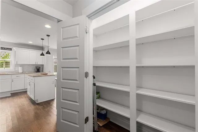 a kitchen with white cabinets and appliances