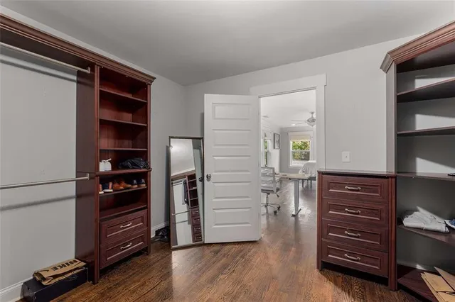 a view of walk in closet with clothes and shoes