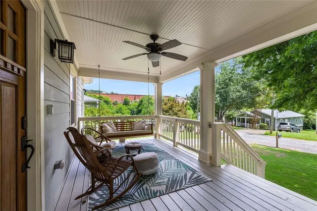 a view of a porch with furniture and a yard