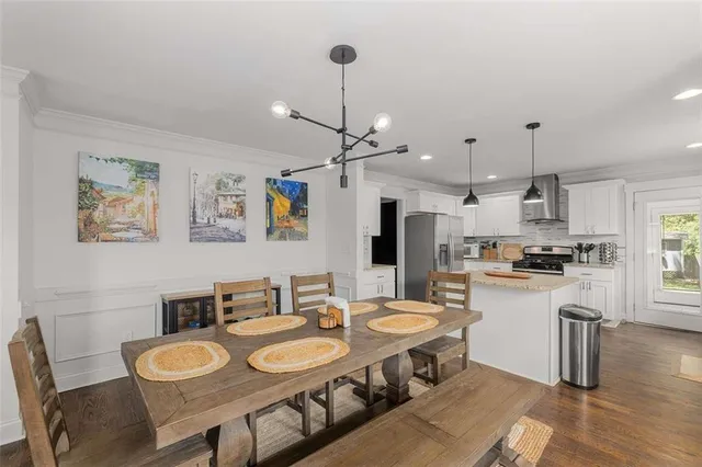 a large kitchen with a table and chairs