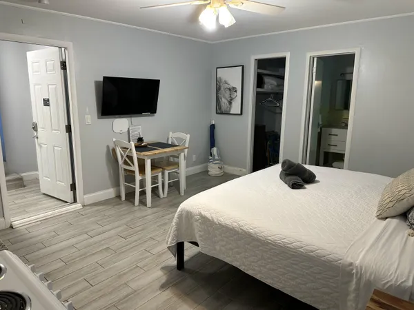 a bedroom with a bed and a flat screen tv