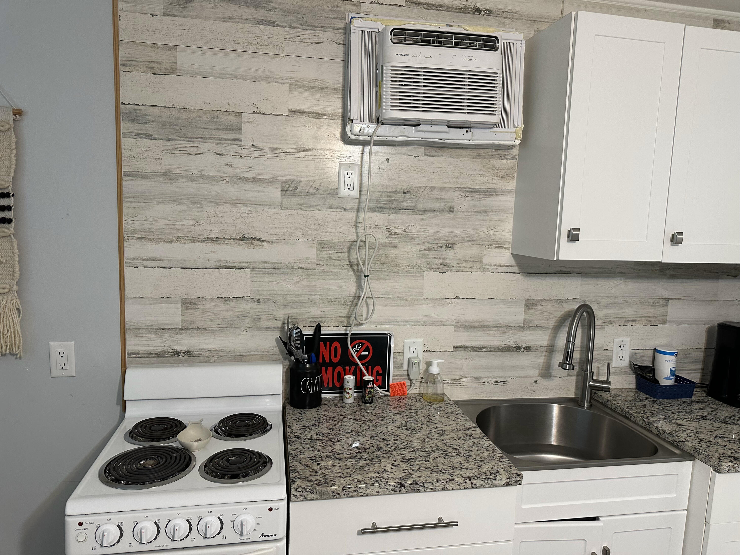 1258 Beach Road, Unit 9 STUDIO Singer Island, FL 33404 - Photo 6 of 13 a kitchen with a stove and a cabinet