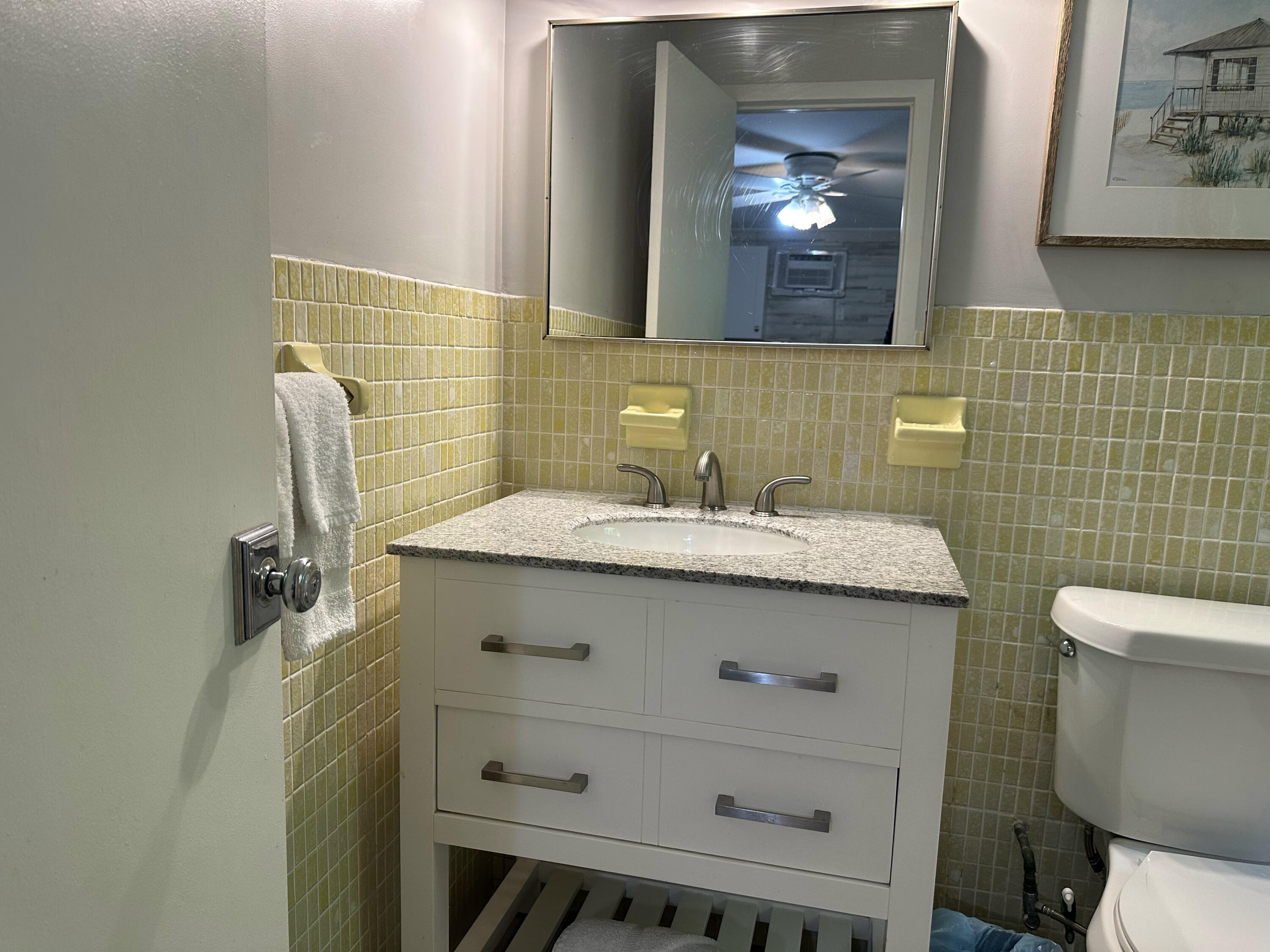 1258 Beach Road, Unit 9 STUDIO Singer Island, FL 33404 - Photo 10 of 13 a bathroom with a sink mirror and toilet