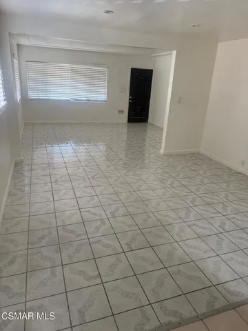 a view of an empty room and a window