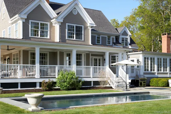 a house with swimming pool in front of it
