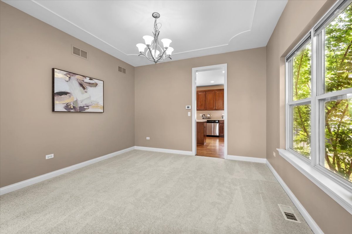 1112 Stonehaven Circle Aurora, IL 60504 - Photo 14 of 28 a view of a chandelier and window in a room