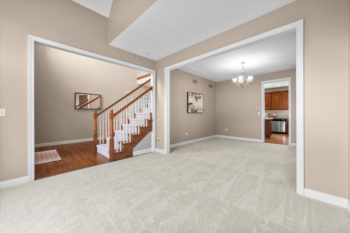 1112 Stonehaven Circle Aurora, IL 60504 - Photo 15 of 28 a view of an empty room with stairs and a window