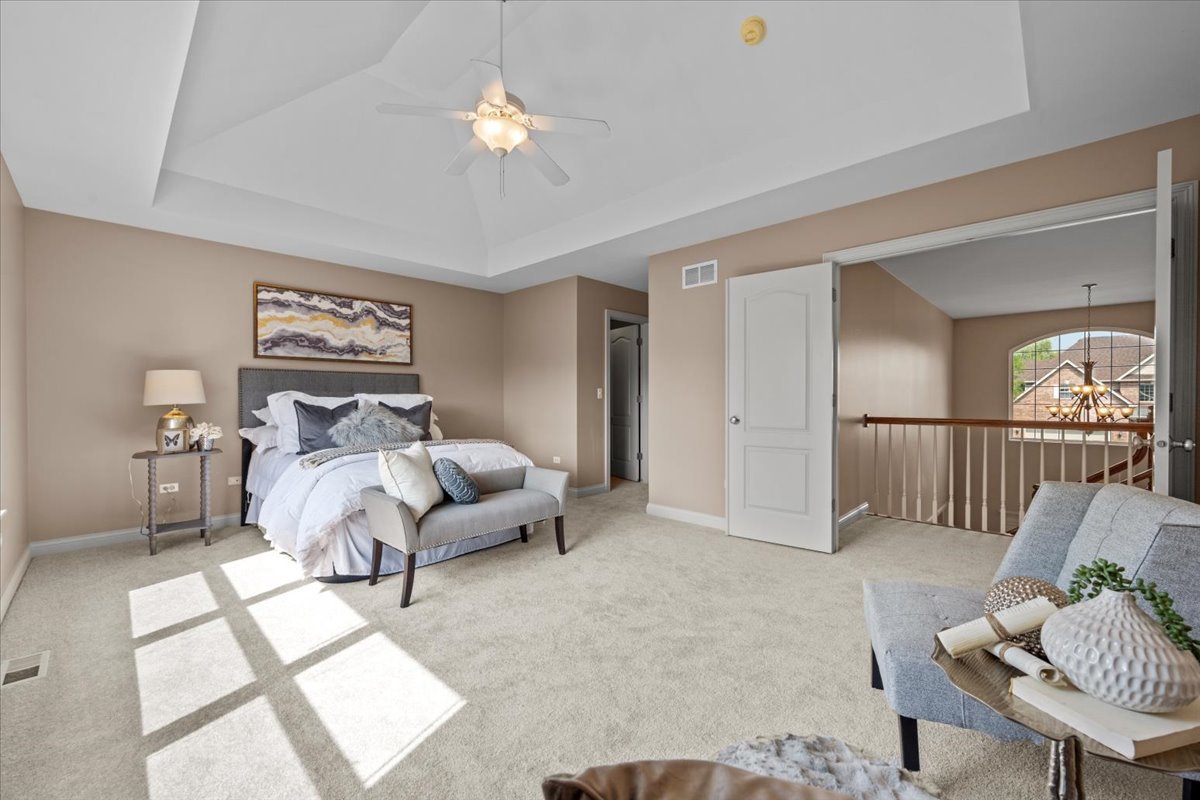 1112 Stonehaven Circle Aurora, IL 60504 - Photo 18 of 28 a bedroom with furniture and a chandelier