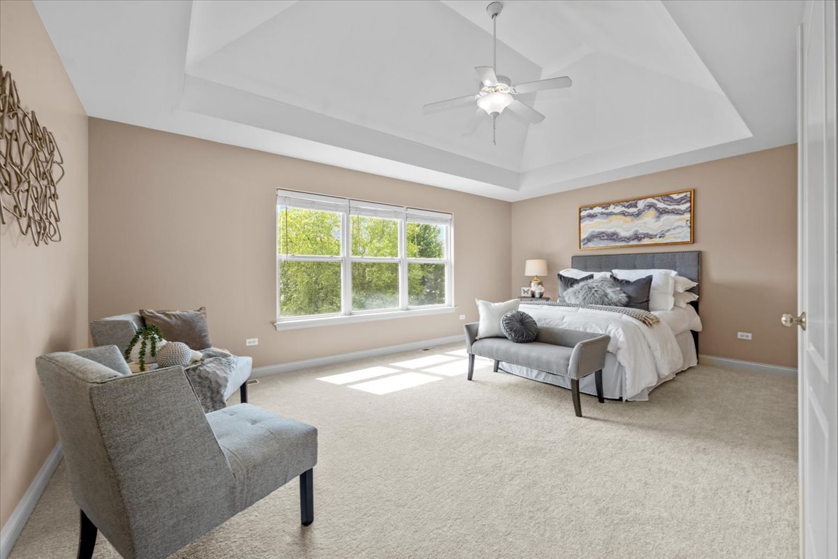 1112 Stonehaven Circle Aurora, IL 60504 - Photo 19 of 28 a spacious bedroom with a bed and a couch