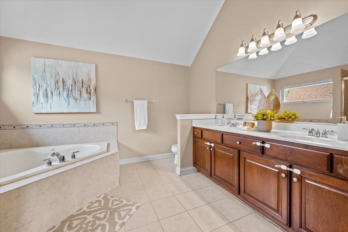 1112 Stonehaven Circle Aurora, IL 60504 - Photo 20 of 28 a spacious bathroom with a tub sink and mirror