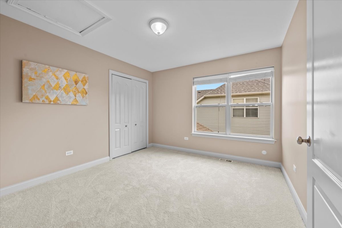 1112 Stonehaven Circle Aurora, IL 60504 - Photo 23 of 28 an empty room with windows