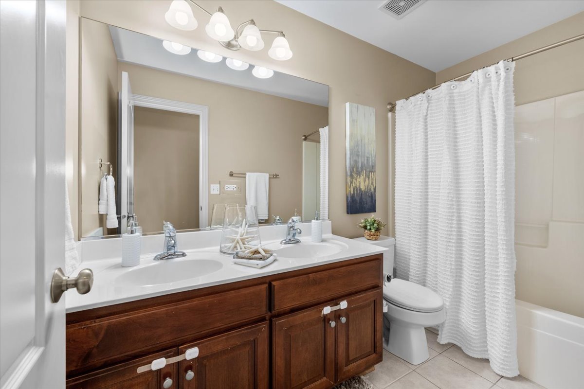 1112 Stonehaven Circle Aurora, IL 60504 - Photo 25 of 28 a bathroom with a double vanity sink mirror and toilet