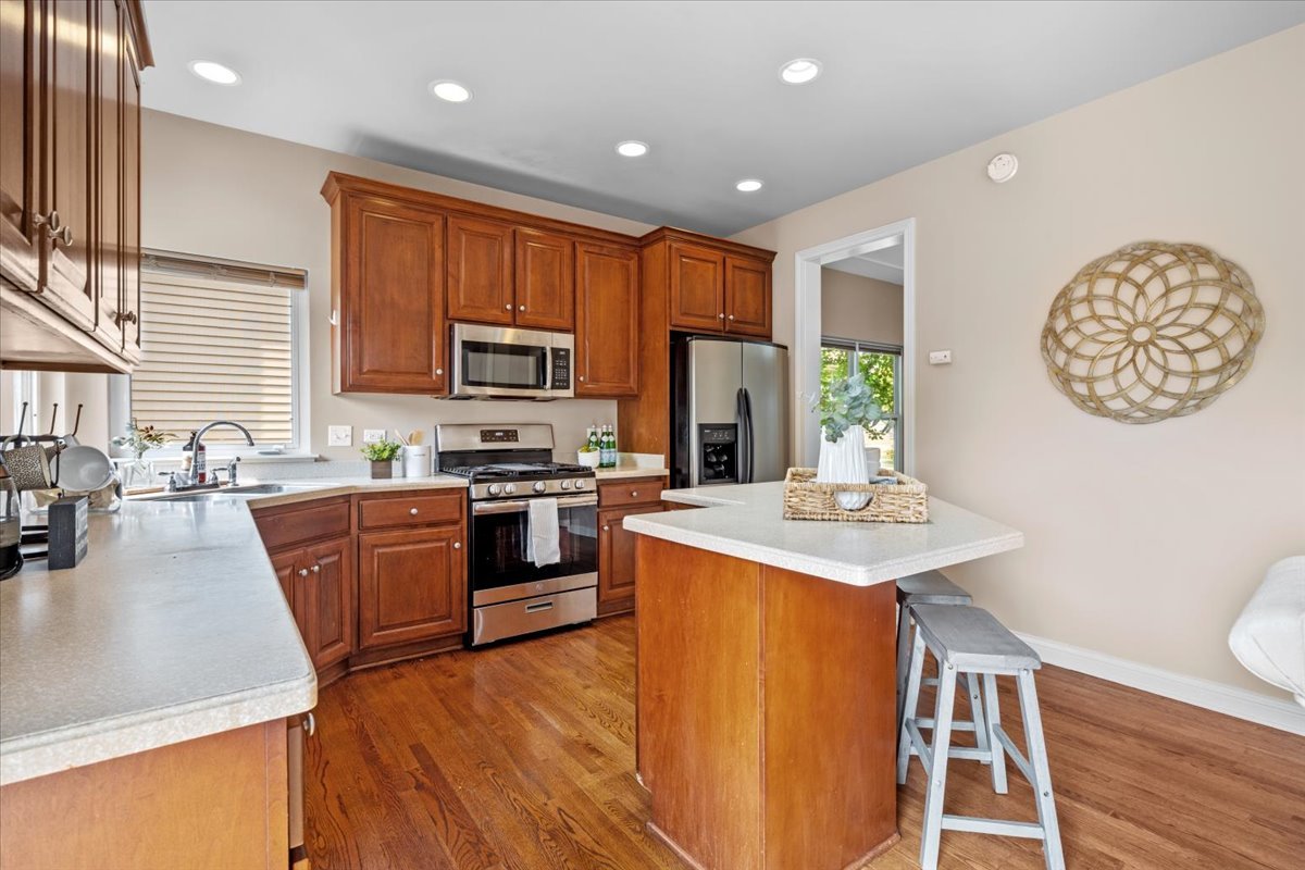 1112 Stonehaven Circle Aurora, IL 60504 - Photo 10 of 28 a kitchen with stainless steel appliances granite countertop a refrigerator a stove top oven a sink and dishwasher