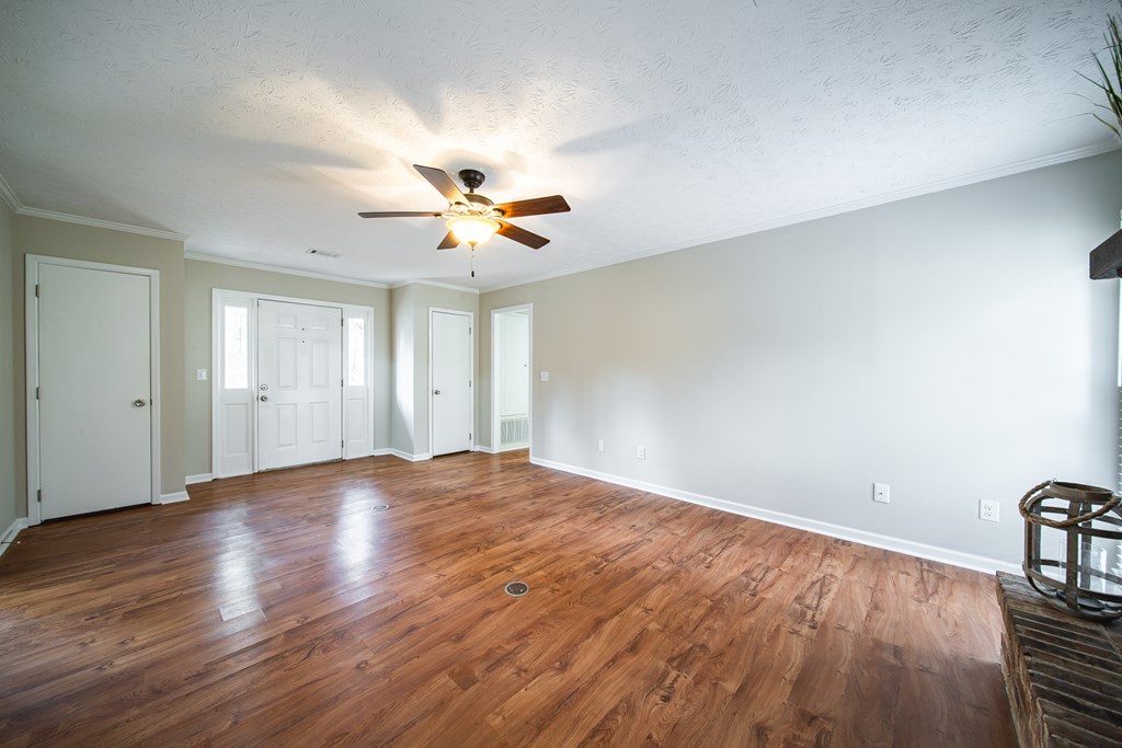 907 Eden Street Columbus, GA 31904 - Photo 11 of 26 a view of an empty room with a window and wooden floor