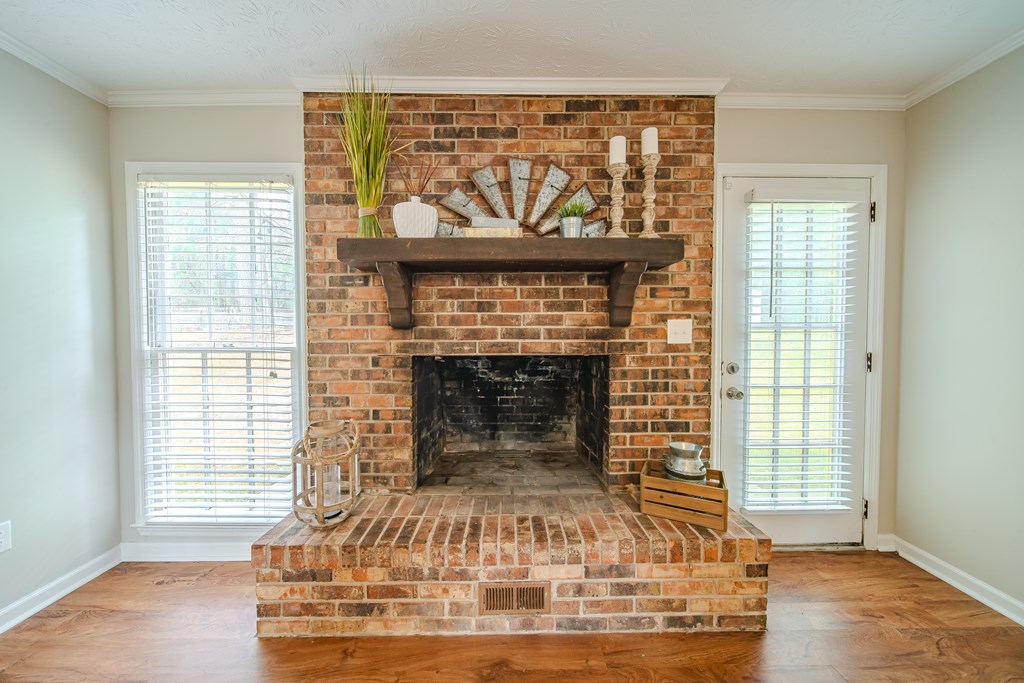 907 Eden Street Columbus, GA 31904 - Photo 12 of 26 a living room with a fireplace and wooden floor
